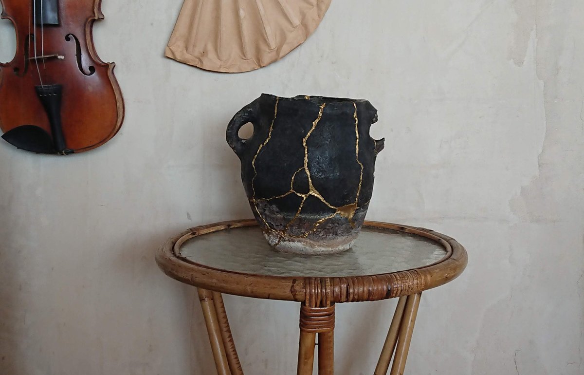 Ceramic vessel repaired with visible gold kintsugi lines