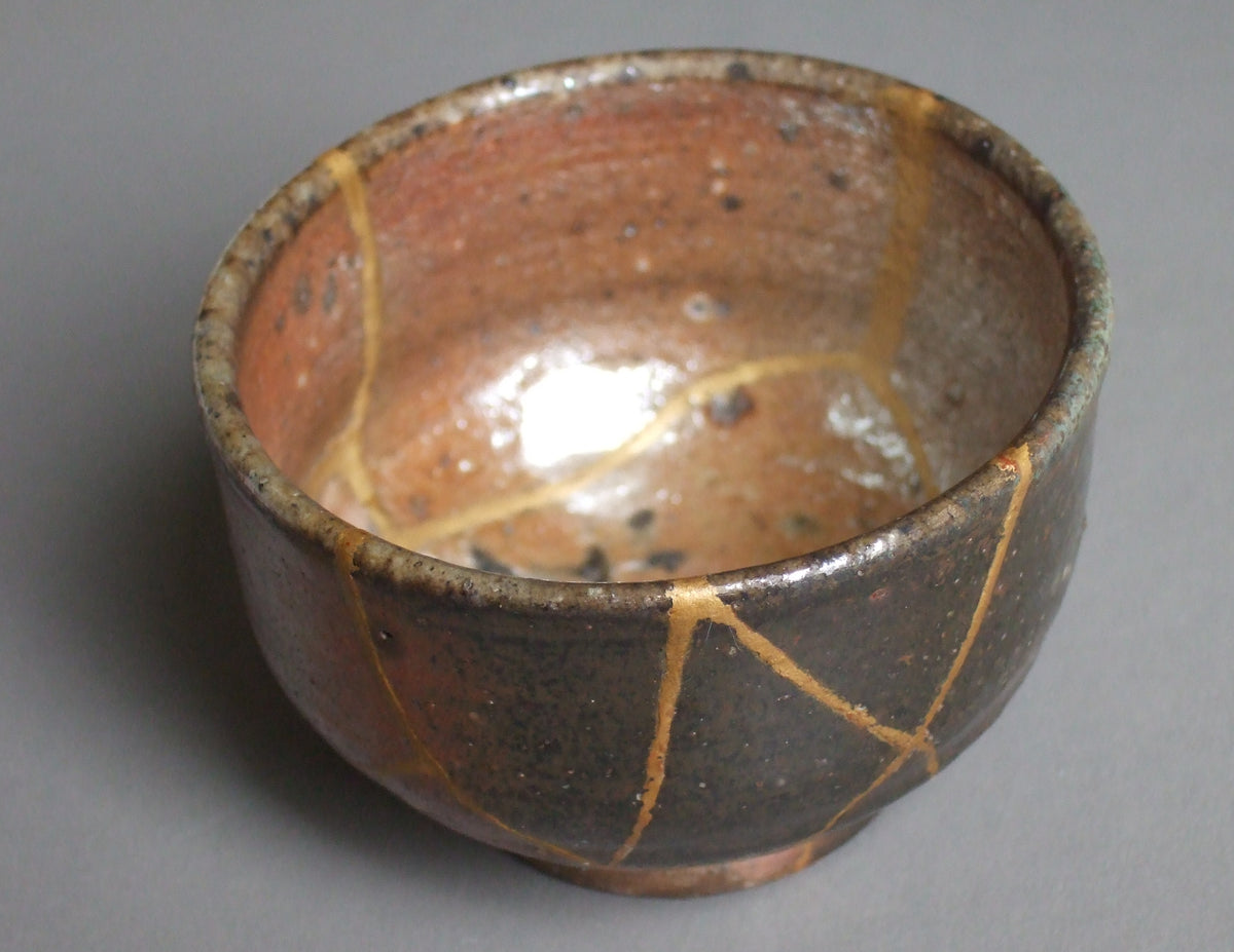 Japanese ceramic guinomi repaired with visible gold-lacquer Kintsugi lines
